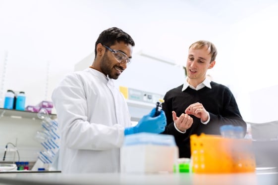 Two persons standing in a laboratory 